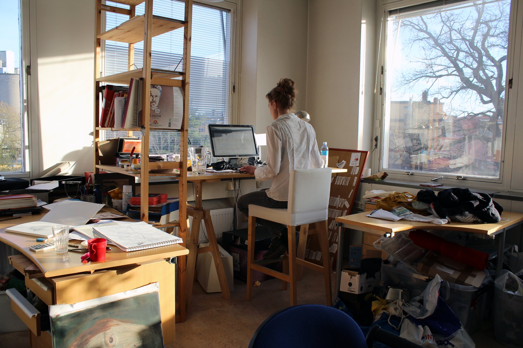 A member working at her desk in a sunlit Platform studio